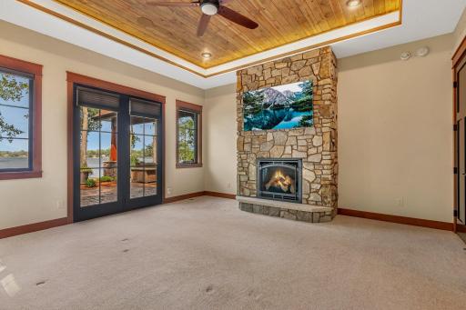 Spacious primary bedroom featuring a cozy gas fireplace, creating a warm and inviting retreat.