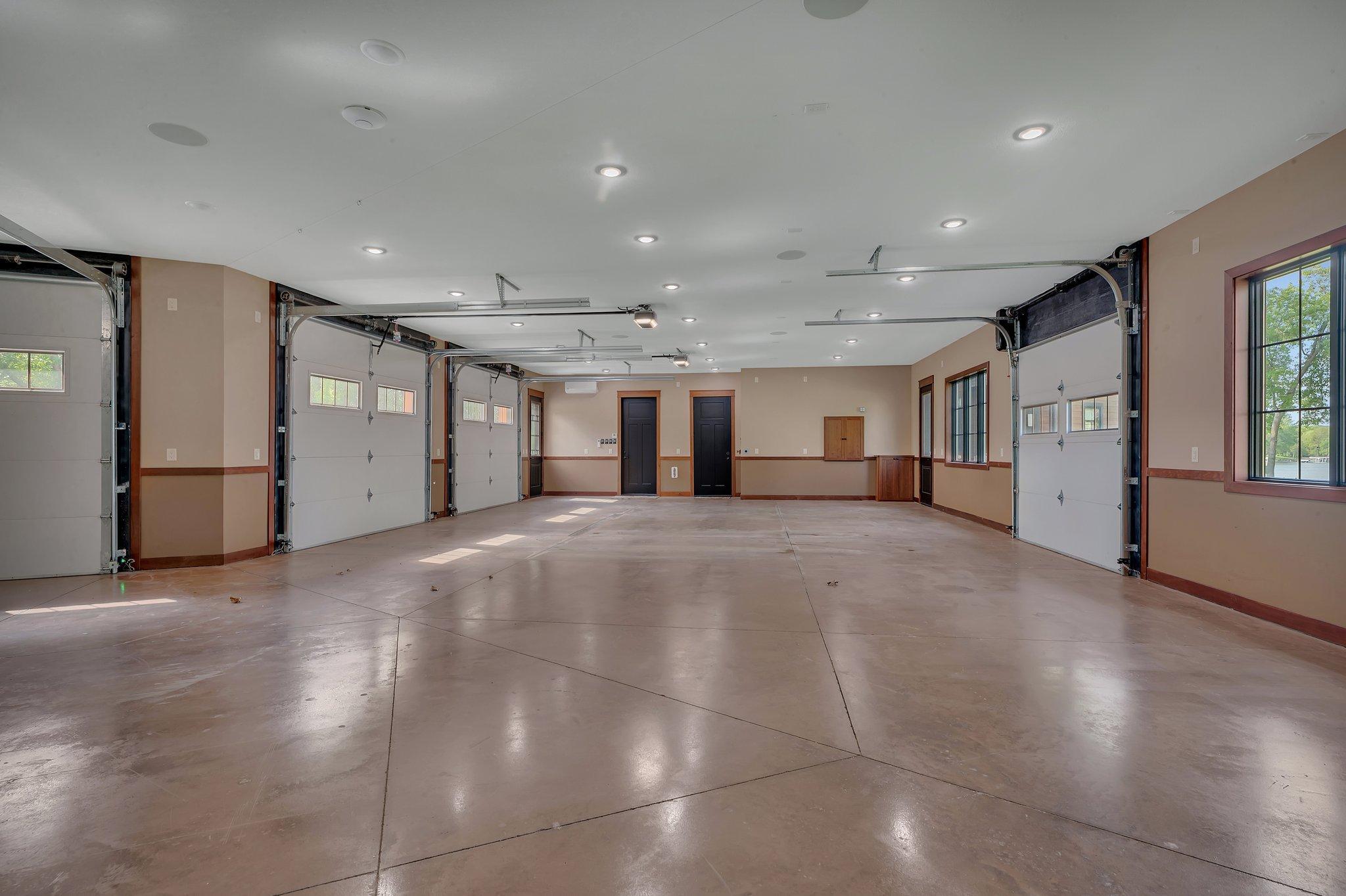 Spacious 5-car garage with a convenient half bath, offering plenty of room for vehicles, storage, and workshop needs.