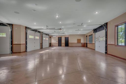 Spacious 5-car garage with a convenient half bath, offering plenty of room for vehicles, storage, and workshop needs.