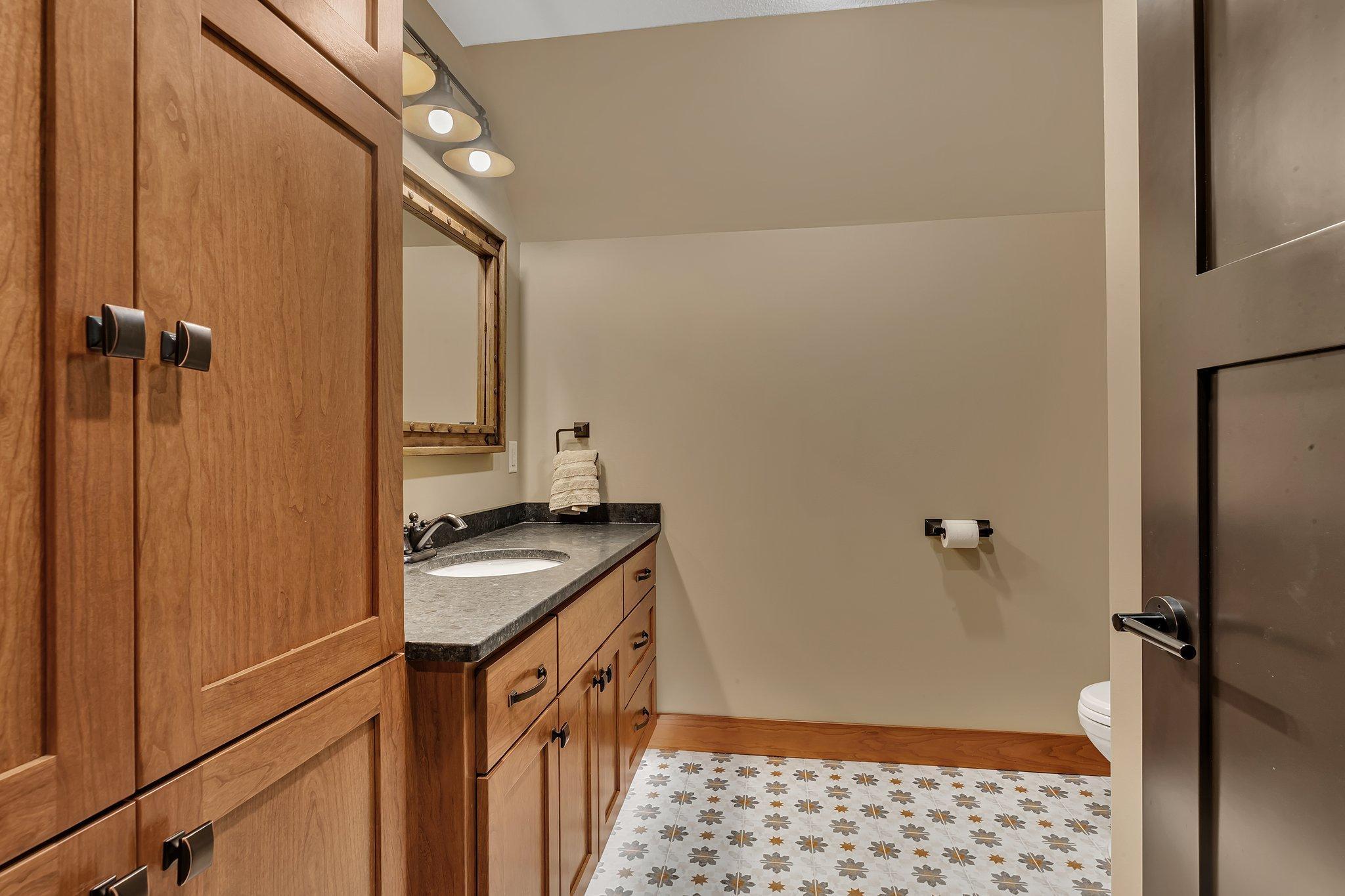 Stylish 3/4 bath featuring custom tile work and modern fixtures, combining function with elegant design.