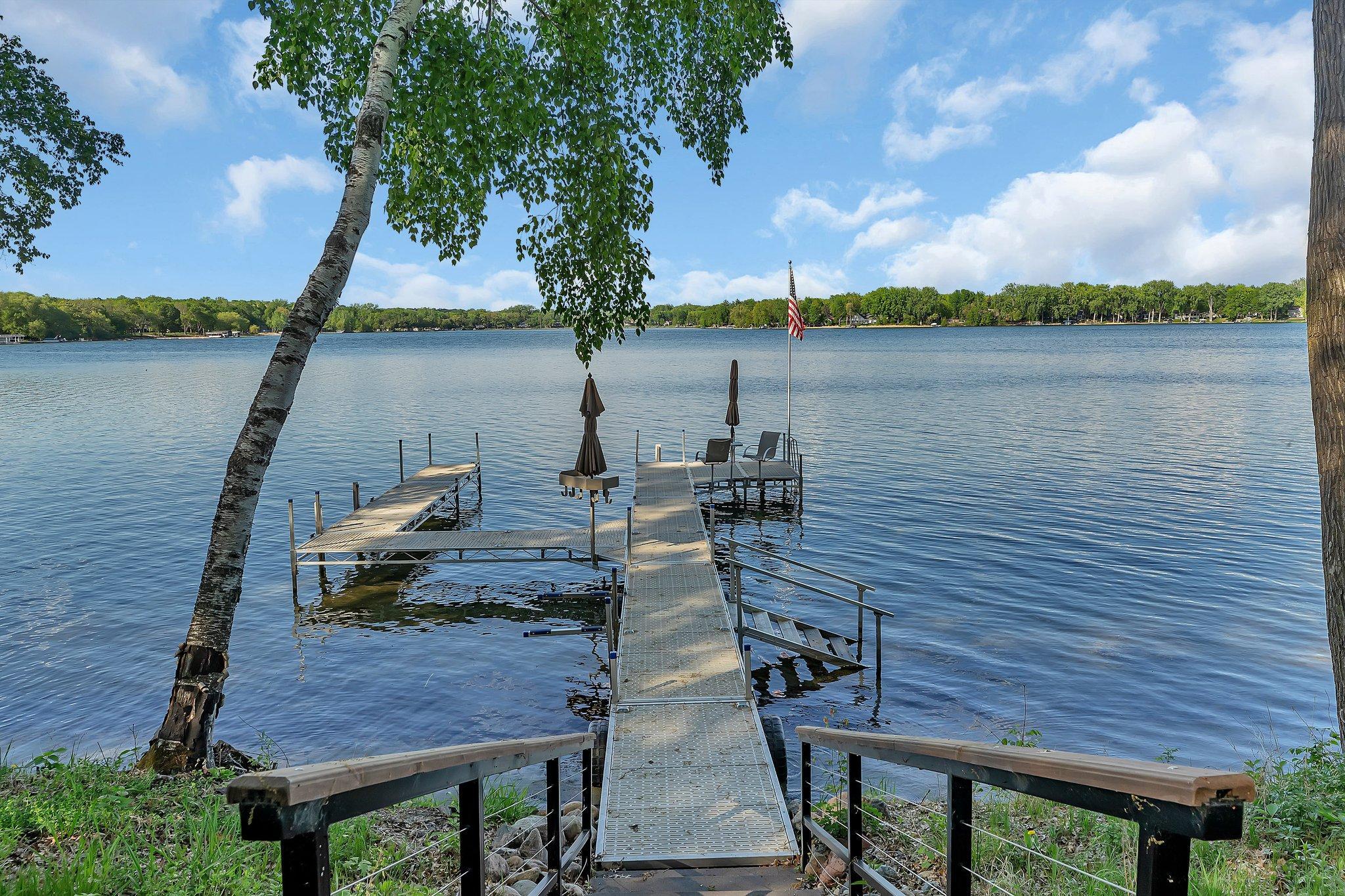 Spacious dock featuring ample seating, shaded by stylish umbrellas, offering a perfect spot to relax and enjoy the water.