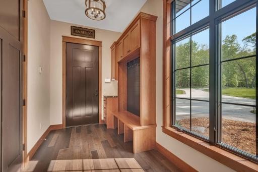 Garage entry into the home opens into a well-planned area with built ins for everyday functionality.