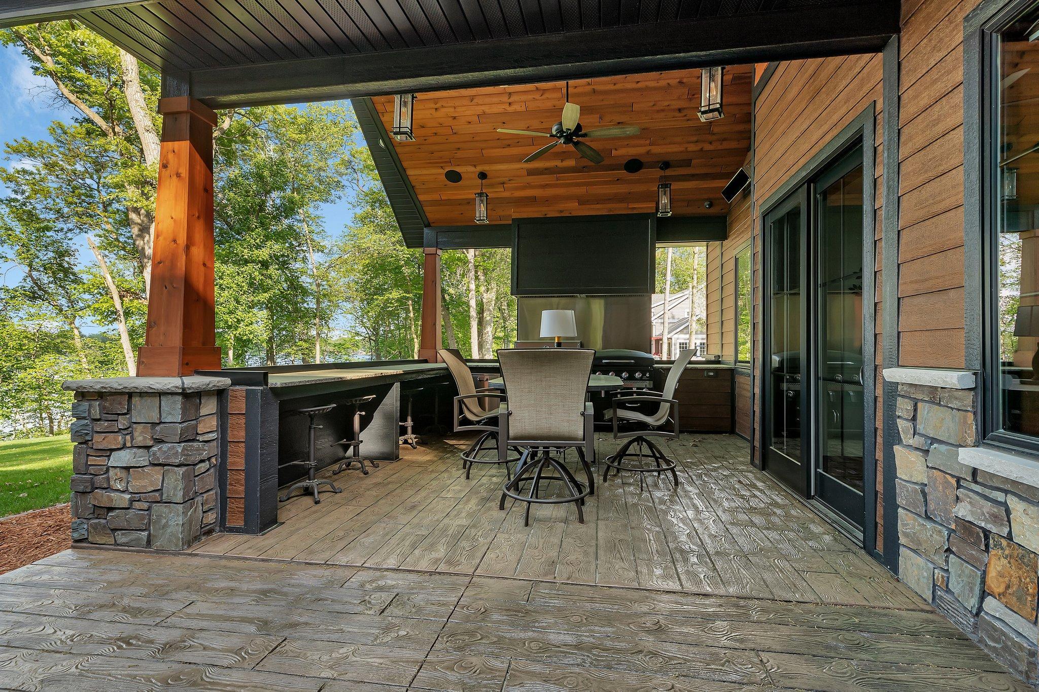Modern patio with a fully equipped outdoor kitchen, infrared heating for year-round comfort, and built-in speakers for seamless outdoor entertainment.