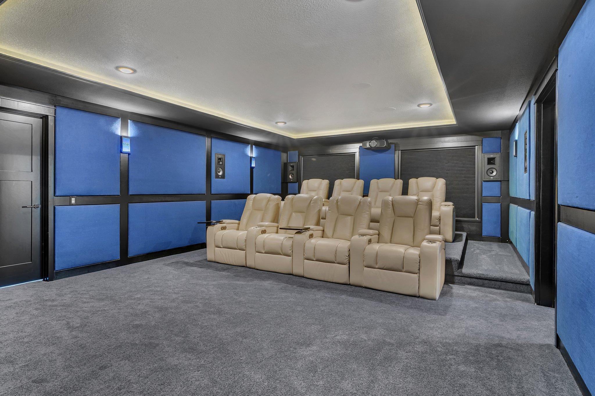 Theater room with tiered seating for optimal viewing, designed for comfort and a true cinematic experience at home.