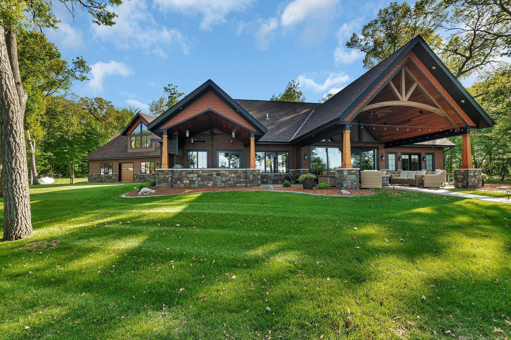 Stunning lakeside view showcasing expertly arranged landscaping, with carefully placed rocks and vibrant flowers that enhance the natural beauty of the surroundings.