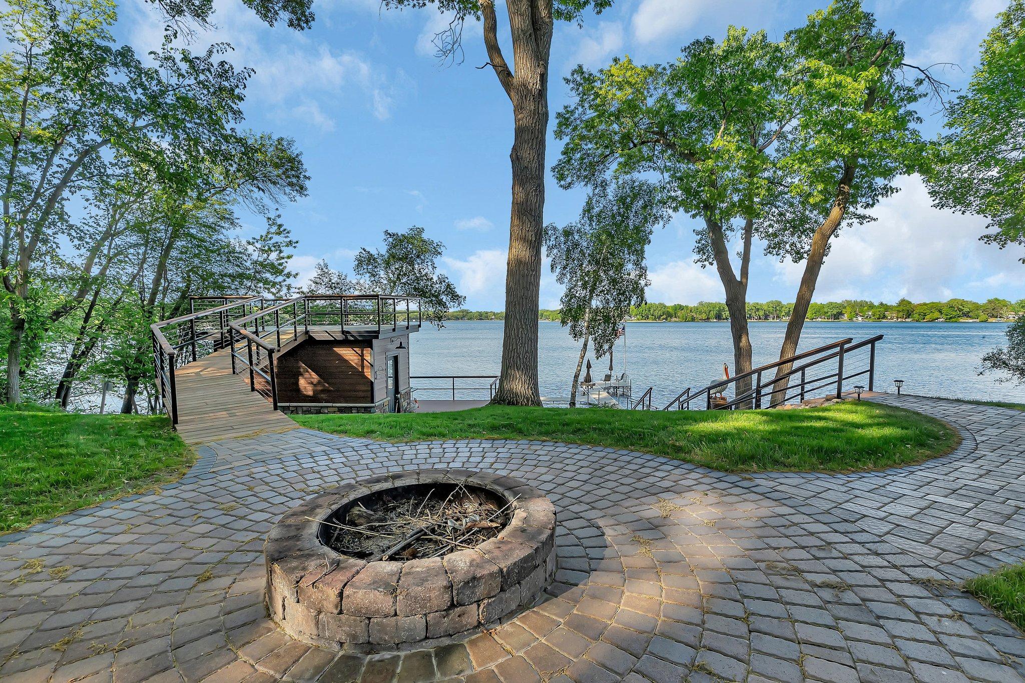Enjoy stunning lakeside views while relaxing by the firepit, the perfect spot for unwinding and taking in the peaceful surroundings.
