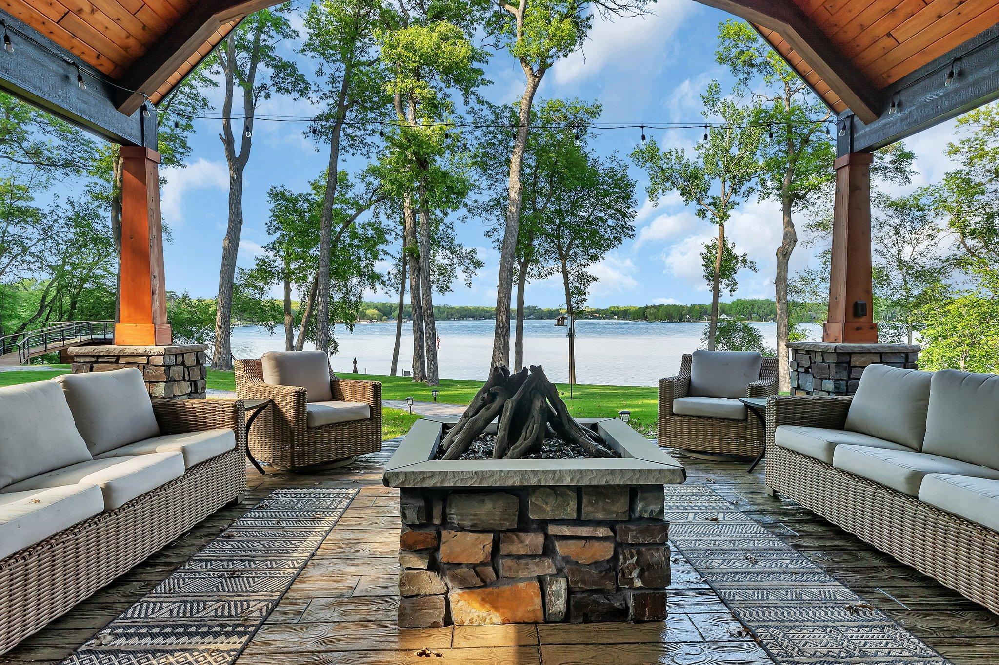 Stamped concrete patio with built-in gas firepit, vaulted cover, and stunning views of Big Fish Lake.