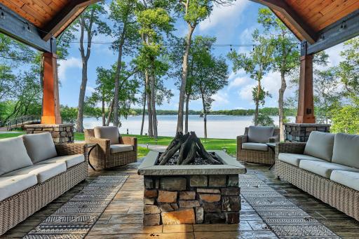 Stamped concrete patio with built-in gas firepit, vaulted cover, and stunning views of Big Fish Lake.