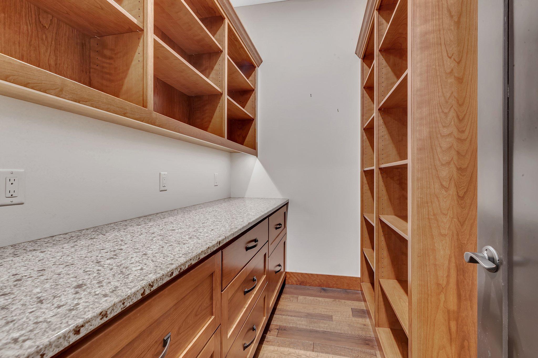 A generous pantry behind the main kitchen with so much storage room.