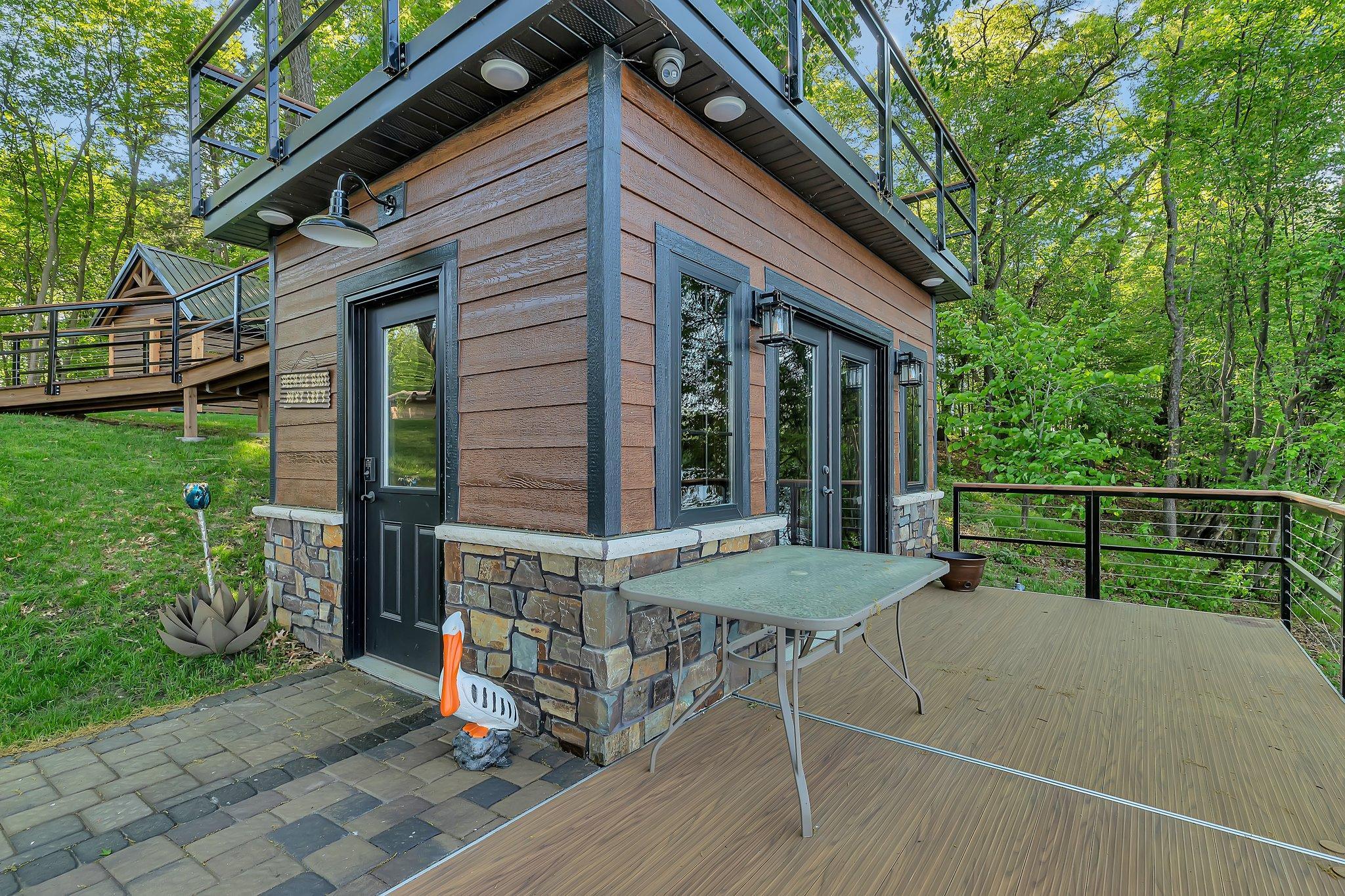 Fully equipped fish house featuring a convenient serving line, built-in speakers, and a TV—perfect for entertaining and enjoying lakeside gatherings.