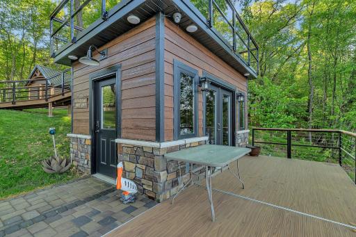 Fully equipped fish house featuring a convenient serving line, built-in speakers, and a TV—perfect for entertaining and enjoying lakeside gatherings.