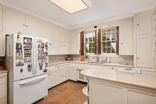 The authentic kitchen has cabinets to the ceiling and sold surface countertops