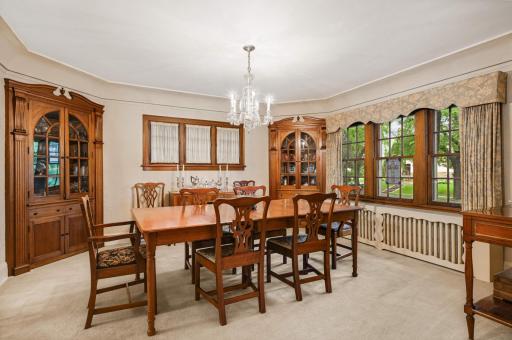 The Formal Dining room features 2 stately mahogany corner cabinets