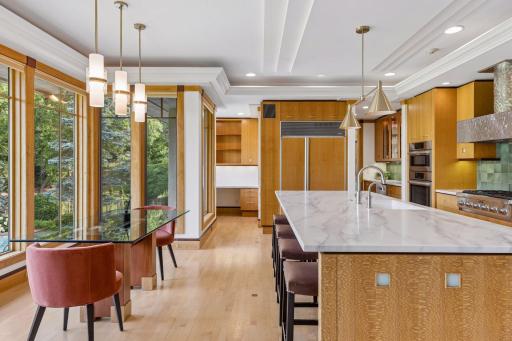 A built-in Sub-Zero refrigerator blends into the surrounding custom cabinets.