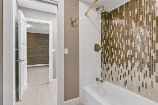 Custom tilework in the shower/tub combo with doors on each side for privacy.