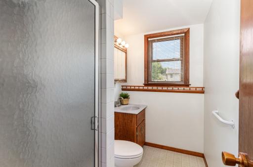 The 3/4 lower level bathroom has a window facing the front yard.