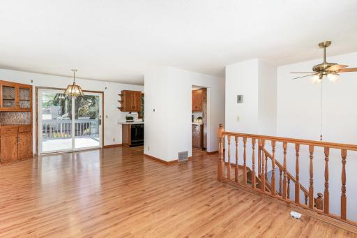 A built-in corner hutch is located in the informal dining room with an Anderson sliding glass door to your large deck.