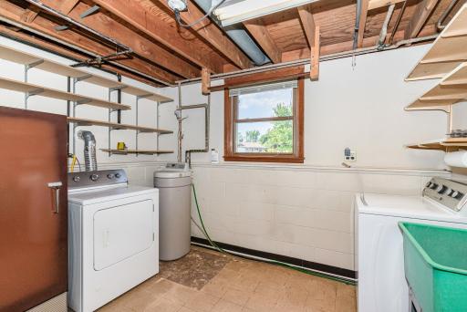The laundry/utility room has a sink and ample shelving for storage. The Furnace and AC were replaced in 2022 and water heater replaced in 2021.