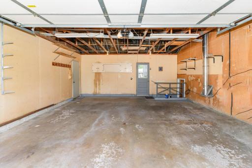 The 2 car garage has a service door to the backyard and steps down to the family room. There is a wall separating the two stall from the 1 stall. He used this side for the cars.