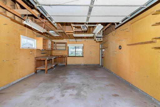 The 3rd stall also has windows facing the backyard and side yard to bring in an abundance of light. This side is heated and was used as his work shop.