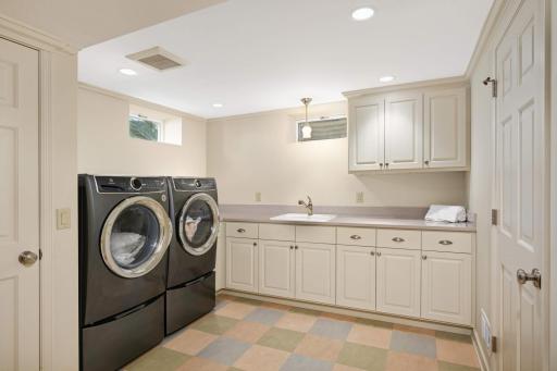 A very nice laundry room plus an extraordinary amount of storage and a workshop / future wine cellar