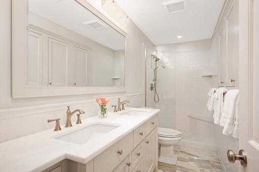 Upper level full bath has a a double vanity and large shower