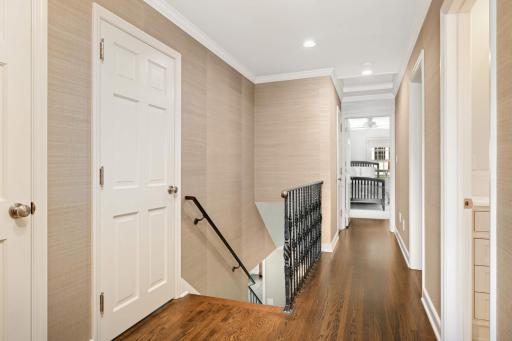 The second-floor open landing accesses 4 bedrooms, two full baths, and two hallway storage closets