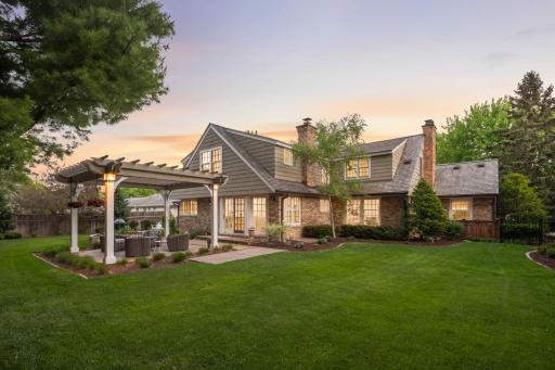 A bayed wall of windows and a sliding door flow out to the magnificent, fenced backyard