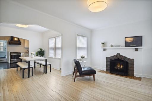 The open living and dining rooms are flooded with natural light and have beautiful hardwood floors