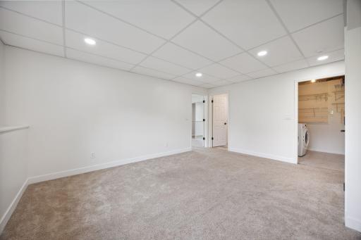On the opposite side of the family room is the laundry room. Conveniently located just a few steps down from your main and upper levels.