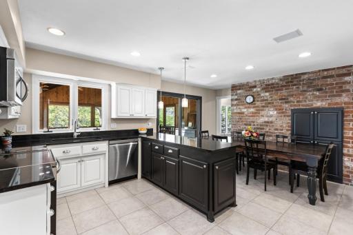 Spacious kitchen with granite countertops and ample prep space.