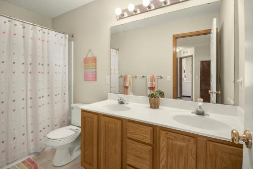 Full upper-level bath has double sink vanity.