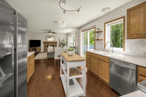 Handy center island, SS appliances, wall pantry to left of refrigerator, and convenient pull-out lower-level cabinet drawers.