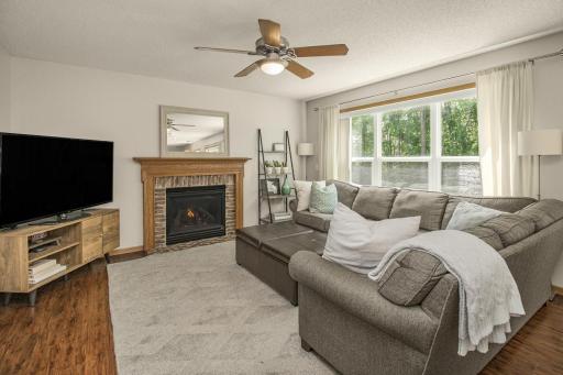 The cozy gas fireplace is the center of this spacious family room.