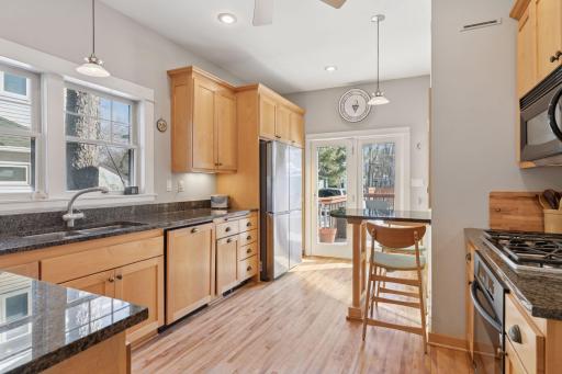 Charm meets modern convenience. Tastefully updated kitchen provides ample cabinets, prep space, newer appliances, and access to the deck and back yard.