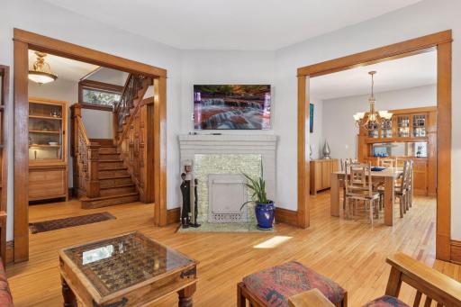 Original two sided fireplace between living and dining rooms adds charm and is in need of updating