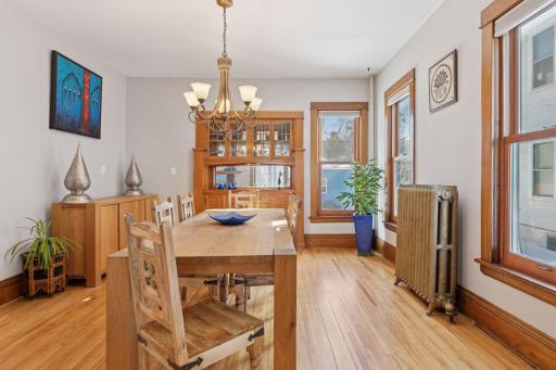 Diners are greeted by a charming built-in buffet, an original decorative radiator, wood floors and newer windows.