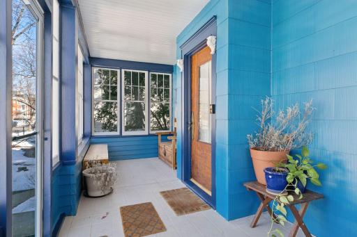 Quaint screen porch ideal for a quiet spell or engaging with neighbors
