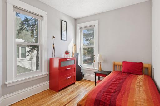 Additional junior bedroom on the upper level. Note the updated windows and hardwood floors