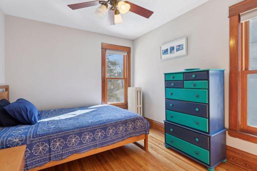 Cute junior bedroom has wood floors and a large closet