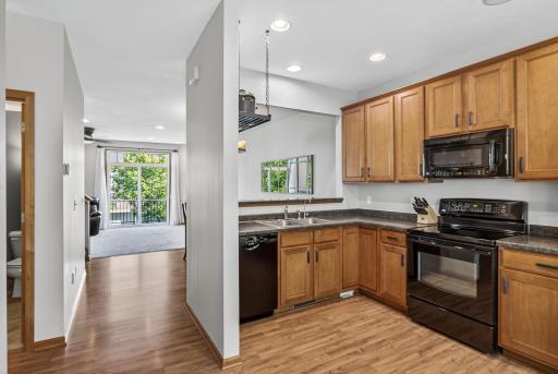Beyond the kitchen you will find the dining room and living room all on the main level. Just to the left you can peek into the wonderful guest bathroom. A convenient bonus in the kitchen is the central vacuum under the cabinet near the sink.
