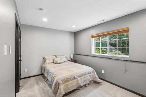 The lower level offers a newly finished bedroom with a private bathroom. This is also a great space for an office or home gym. The window looks out to the wooded front of the house and it is very private.