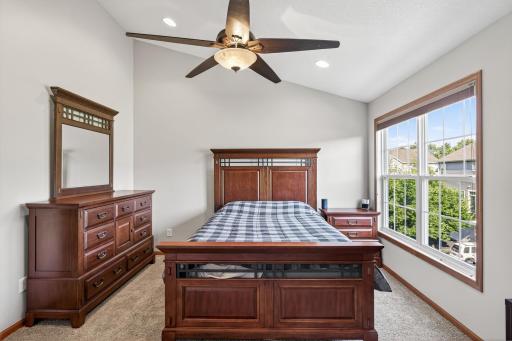 On the upper level you will find the spectacular primary suite complete with new carpet, fresh paint, a ceiling fan, recessed lights on the vaulted ceiling, a private bathroom, and a walk-in closet.