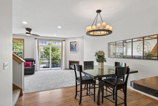 Located in the high demand Dean Lakes area this fantastic townhome is situated on a premium lot that faces a wooded area with lovely nature views. Here you see the light filled dining room and living room with a walkout to the maintenance free deck.