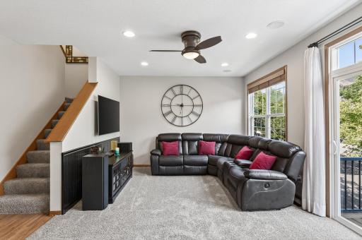 Here is an alternate view of the living room. This space features recessed lights and a built-in speaker system. The stairs on the left will take you to the upper level bedrooms.