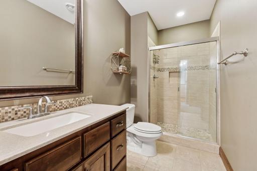 Lower level 3/4 bath with tile floors and shower