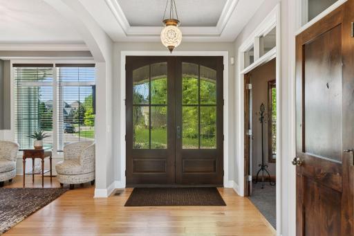 Welcoming entry with tray ceiling and custom lighting