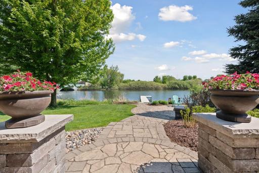 Custom pavers and elegant pillars frame the patio