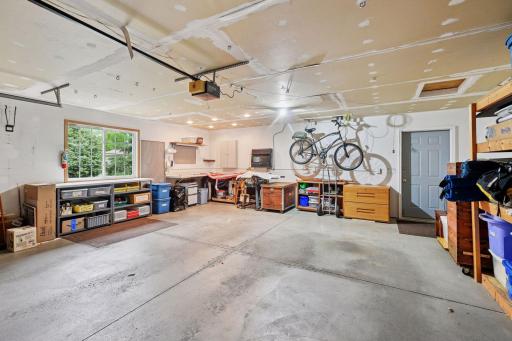 Expansive 2 car garage with great storage and work bench