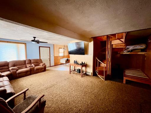 Living room to spiral staircase to upper level